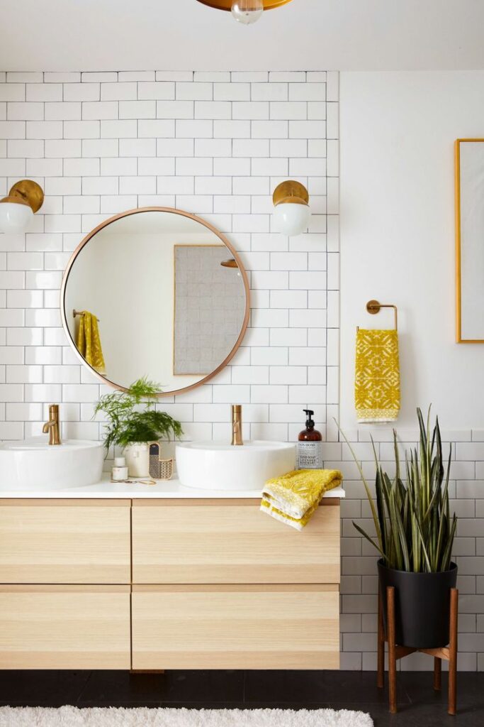 a bathroom vanity with round mirror